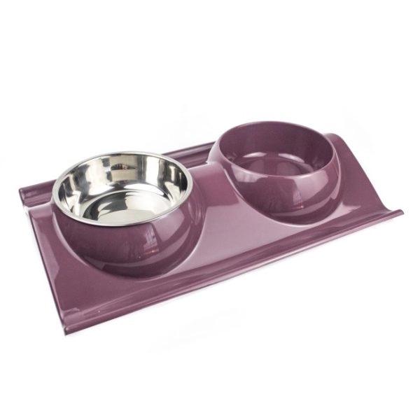 Imagen que muestra el producto Comedero 2 Compartimientos Para Mascotas. Comedero elevado, cuenta con dos recipientes. Material: Plástico    Color: Morado, verde, azul, amarillo                                                                                                   Disponible: Razas pequeñas y medianas. Medidas:  Largo 38 cm * Ancho 25 cm Alto 7,5cm